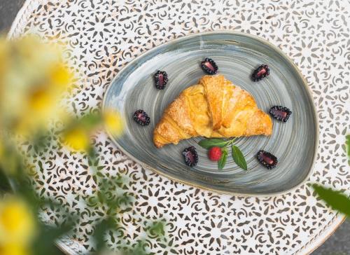 a plate with a pastry and berries on a table at Blackhome Innsbruck Boutique I contactless check-in in Innsbruck