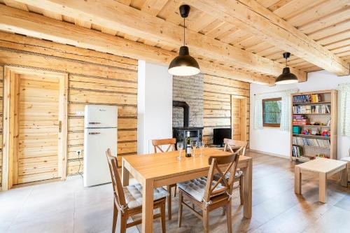 a wooden dining room with a table and chairs at Drevenice Liptov - apartments under the mountains in Lazisko