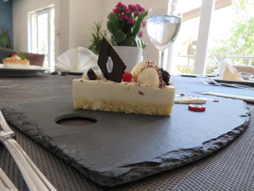 a piece of cheesecake sitting on a table at Hotel Sun in North Nicosia