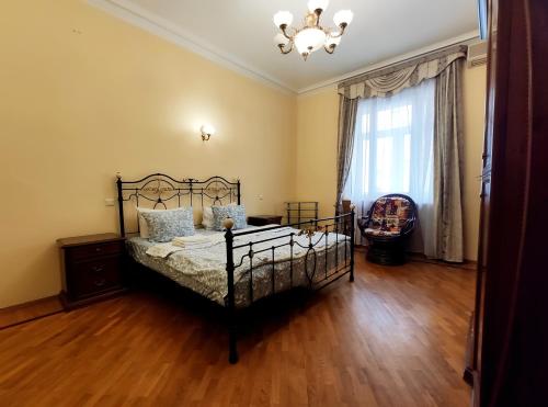 a bedroom with a bed and a chandelier at Tverskaya Street Apartments in Moscow