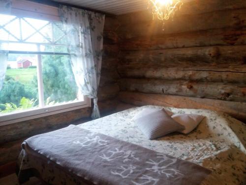 a bedroom with a bed and a window at A room (or 2 or 3) in a Lapland House of Dreams in Rovaniemi