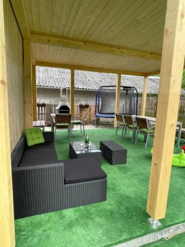 a covered patio with a couch and a table and chairs at Apartment WELLNESS Vlčková in Vlčková
