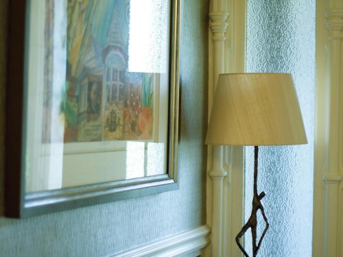 a lamp in a room next to a window at Ascot House in Harrogate