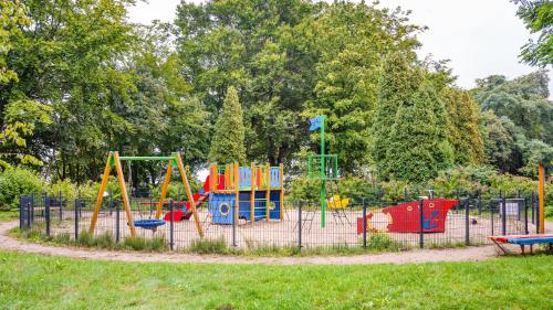 a playground with colorful equipment in a park at Nexo, Sun & Snow in Puck