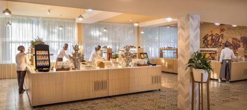 a group of people standing at a counter in a salon at Aminess Vival Port9 Residence in Korčula