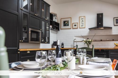 a kitchen with a table with wine glasses on it at Le Clos St Louis in Ax-les-Thermes