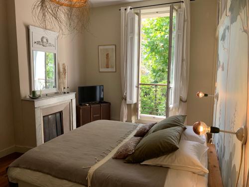 Säng eller sängar i ett rum på Le Transvaal-Maison d'Hôtes