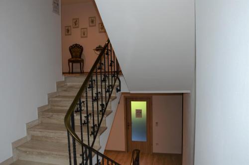 a staircase in a home with a white wall at Ferienhaus Tüchersfeld in Pottenstein