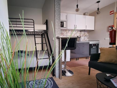 a living room with a bunk bed and a kitchen at Cantinho do Chico in Vila Nova de Gaia