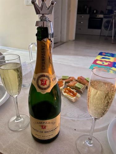 a bottle of champagne next to two glasses of wine at BELKA GOLF RESİDENCE Deluxe apt Poolside BELEK in Belek