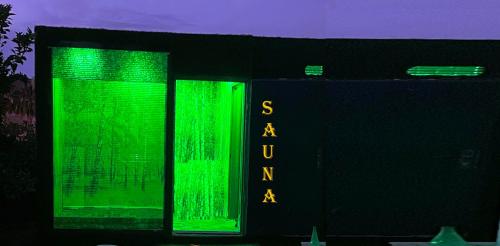 a green sign on the side of a building at BELKA GOLF RESİDENCE Poolside apt1 Belek in Belek