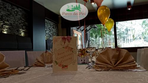 a table with balloons and a sign on top of it at Parco dei Pini - Sila Wellness Hotel in Taverna