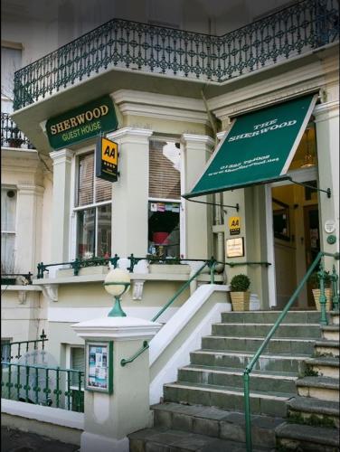a building with a green sign in front of it at The Sherwood Guest House in Eastbourne