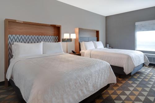 a hotel room with two beds and a window at Holiday Inn - Erie by IHG in Erie