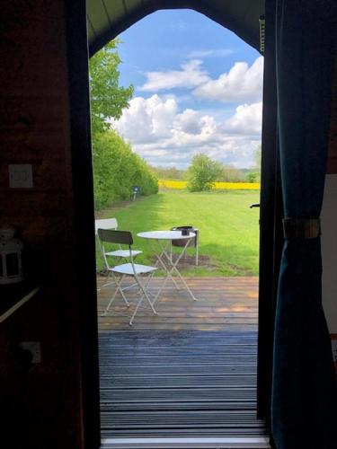 a view of a table and chairs through a door at Rockinghams Farm in Layer Marney