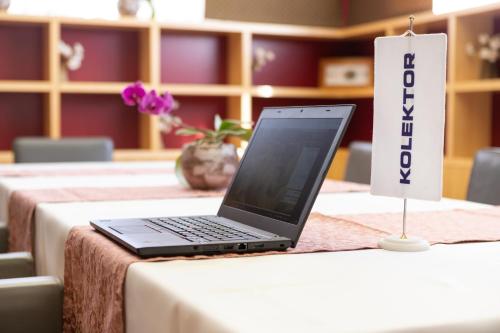 a laptop computer sitting on top of a table at Hotel Jozef in Idrija