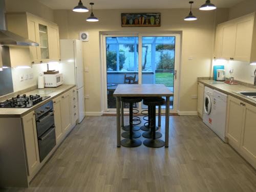 a kitchen with a table in the middle of it at 3 Bedroom Home with Welcome Breakfast near Beaches in Ramsgate