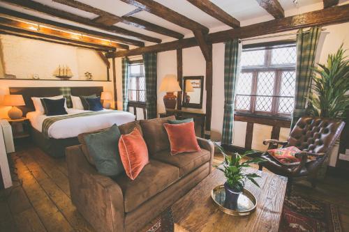 a living room with a bed and a couch and a bed at Bayards Cove Inn in Dartmouth