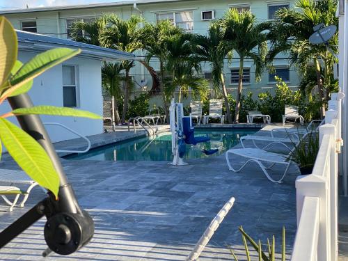 a pool at a hotel with a resort at Pelican By The Sea in Pompano Beach