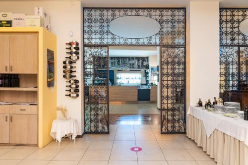 a restaurant with a door leading to a kitchen at Club Azzurro Hotel & Resort in Porto Cesareo