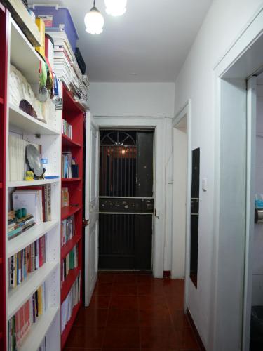 a hallway with white bookshelves and a door at Books&Bed Close to the Lake in Hangzhou
