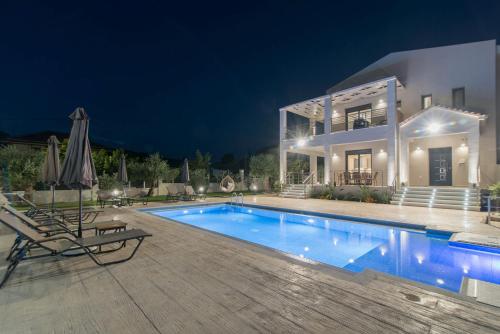 a villa with a swimming pool at night at Daisy's Garden - Villa with Private Pool, Ideal for Large Groups, by ZanteWize in Dhrákas
