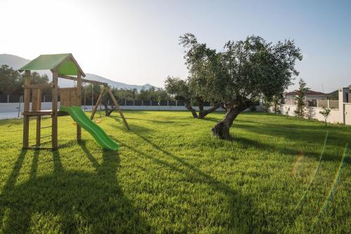 a playground with a slide and a tree at Daisy's Garden - Villa with Private Pool, Ideal for Large Groups, by ZanteWize in Dhrákas