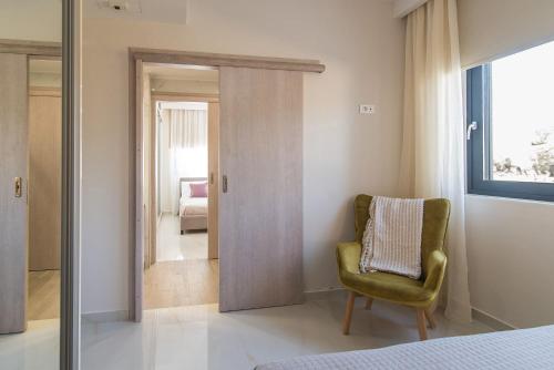 a bedroom with a green chair and a mirror at Daisy's Garden - Villa with Private Pool, Ideal for Large Groups, by ZanteWize in Dhrákas