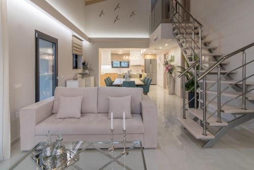 a living room with a white couch and a staircase at Daisy's Garden - Villa with Private Pool, Ideal for Large Groups, by ZanteWize in Dhrákas