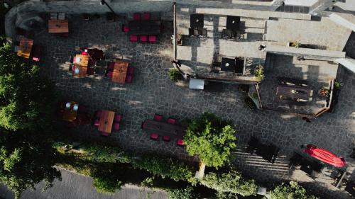 an overhead view of a parking lot with a red car at Rouista Tzoumerka Resort in Vourgareli