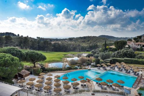 an aerial view of a resort with a pool and umbrellas at Le Fregate Provence in Bandol