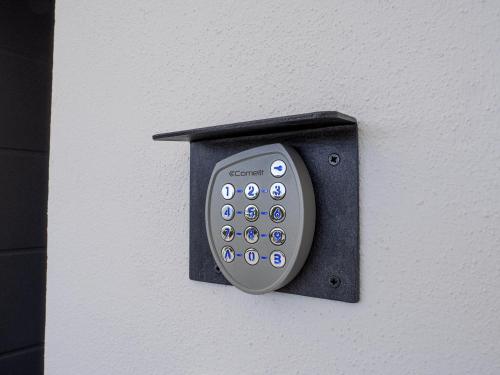 a remote control is attached to a wall at Le Casette sul Mare - Case Vacanza in Cittadella del Capo
