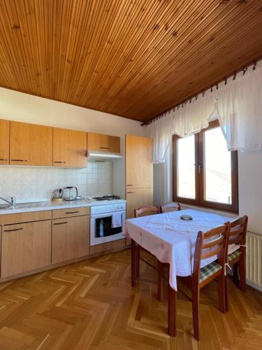 a kitchen with a table and chairs in a room at Rubin Jelsa in Jelsa