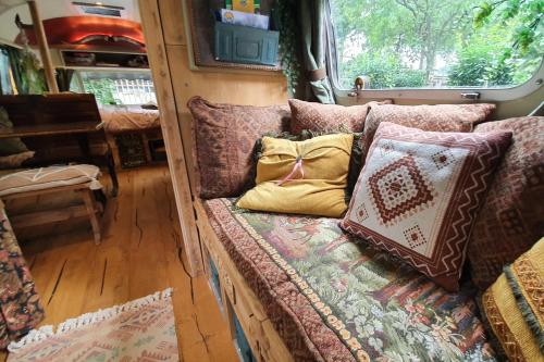 a couch with pillows on it in an rv at AirstreamNB in Schayk