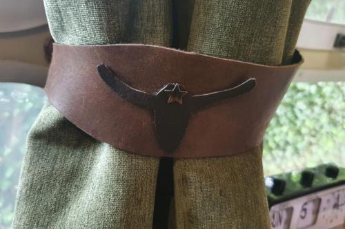 a brown belt with a bull head on a curtain at AirstreamNB in Schayk