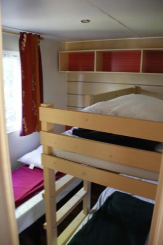 sypialnia z łóżkiem piętrowym i łóżkiem piętrowym w obiekcie Entre sable et feuillus w mieście Camiers