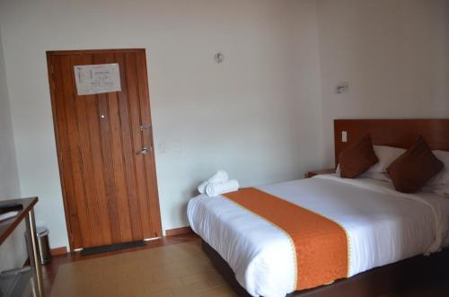 Postel nebo postele na pokoji v ubytování Hotel Santiago Diaz Piedrahita