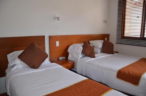 Postel nebo postele na pokoji v ubytování Hotel Santiago Diaz Piedrahita