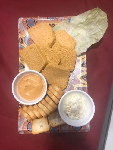 a tray with crackers and dips on a table at Villa Palatina in Bolgues
