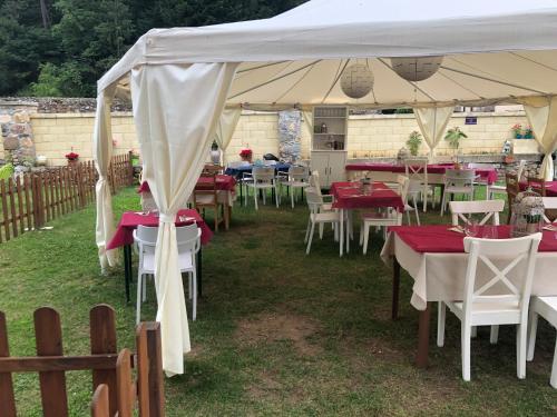 a group of tables and chairs under a tent at Villa Palatina in Bolgues