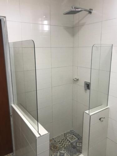 a bathroom with a shower with a glass door at LOS TEROS POSADA DE CAMPO in San Rafael