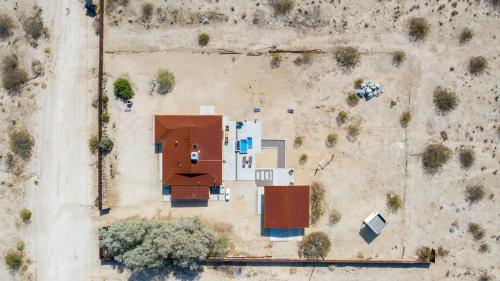 an overhead view of a building in a field at @ Marbella Lane - The Moon Designer Home right behind the JTNP in Joshua Tree