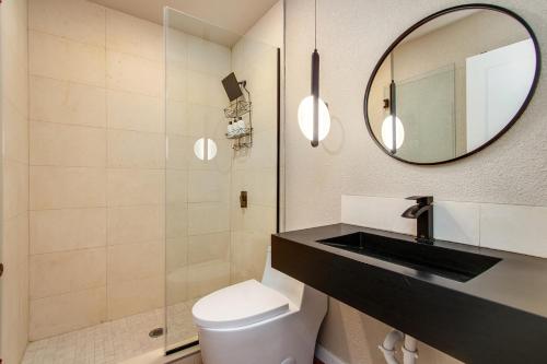 a bathroom with a toilet and a sink and a mirror at @ Marbella Lane - The Moon Designer Home right behind the JTNP in Joshua Tree