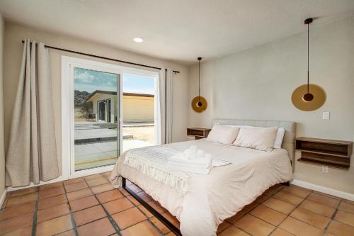 a bedroom with a bed and a large window at @ Marbella Lane - The Moon Designer Home right behind the JTNP in Joshua Tree