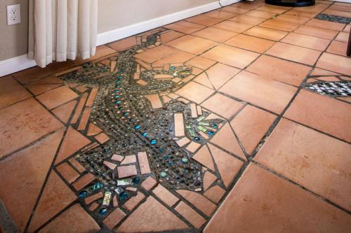 a mosaic on the floor of a room at @ Marbella Lane - The Moon Designer Home right behind the JTNP in Joshua Tree