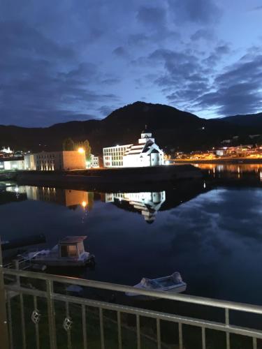 a boat is docked in a harbor at night at Vila Leolaz in Višegrad