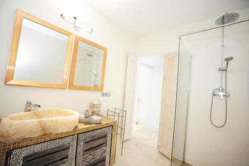 a bathroom with a sink and a shower at Villa La Vida in Cala Llonga