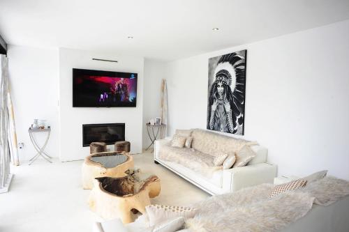 a living room with a couch and a fireplace at Villa La Vida in Cala Llonga