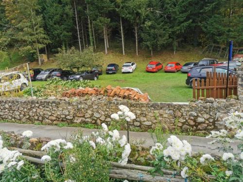 a stone retaining wall with cars parked in a parking lot at Villa Palatina in Bolgues