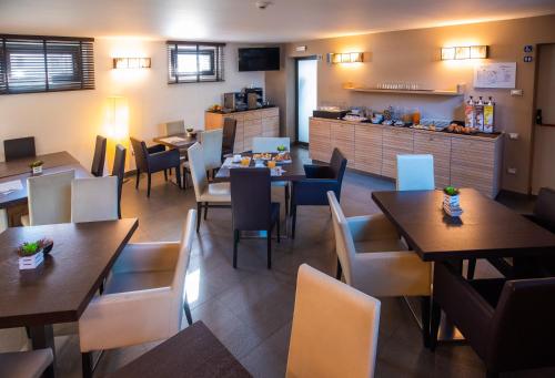 a restaurant with tables and chairs and a counter at Ex-L in Fiume Veneto